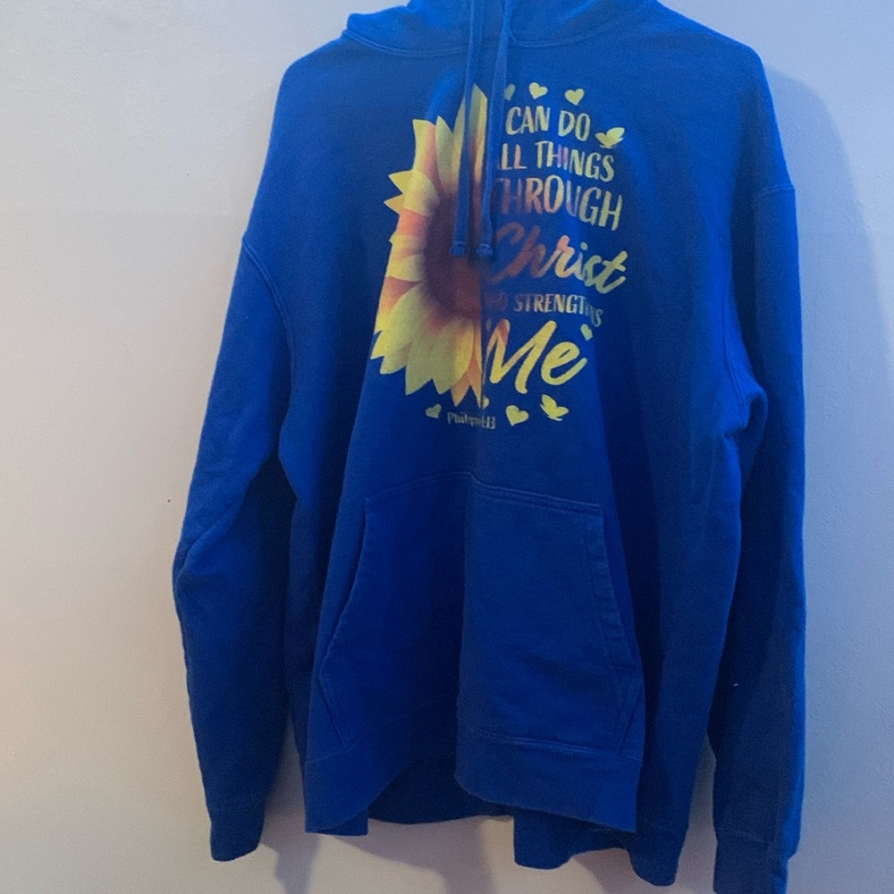 Blue hoodie that says “ I can do all things through Christ who strengthens me.